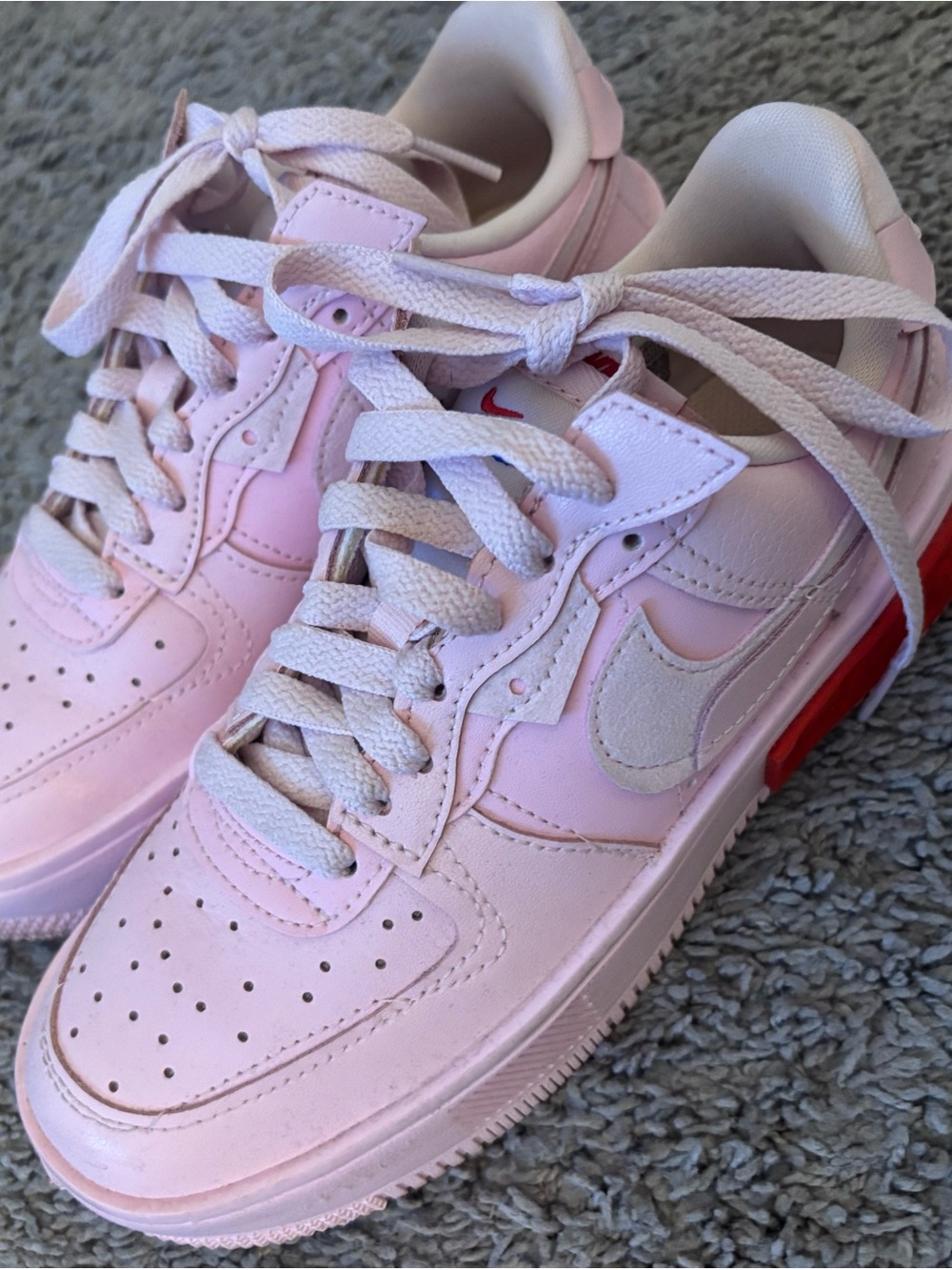 Nike Light Pink Low-Top Sneakers with Red Outsole Accent